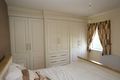 ivory wardrobe doors with reeded pillars and fitted to ceiling